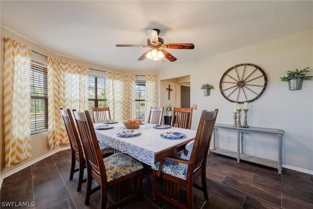 tiled dining space featuring ceiling fan