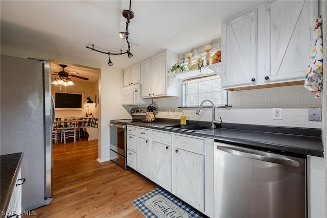 kitchen with ceiling fan, light hardwood / wood-style floors, stainless steel appliances, tasteful backsplash, and white cabinetry