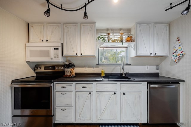 kitchen featuring white cabinets, stainless steel appliances, wood-type flooring, and sink