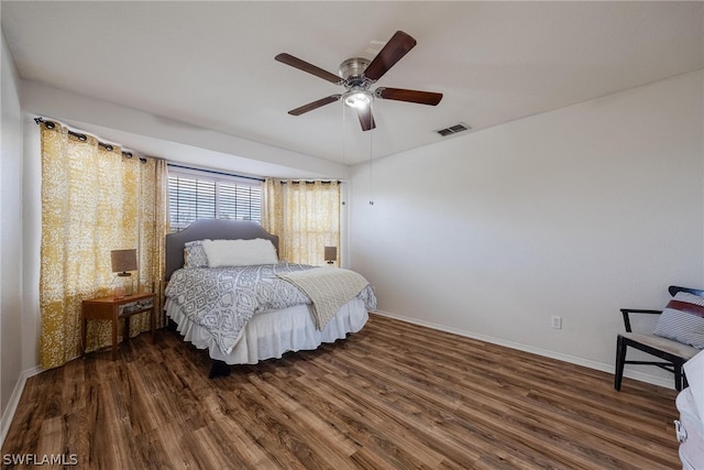 bedroom with ceiling fan and dark wood-type flooring