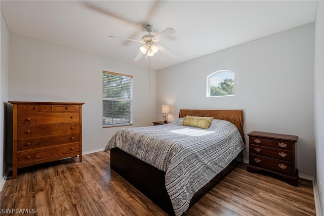 bedroom with ceiling fan and dark wood-type flooring