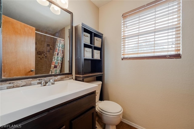 bathroom featuring backsplash, large vanity, and toilet