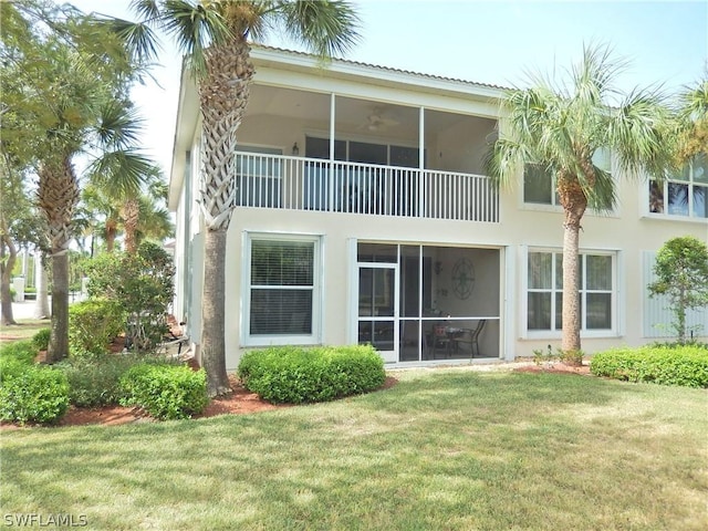 rear view of property featuring a lawn