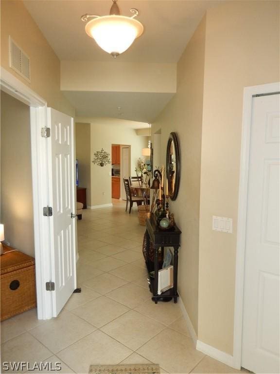 corridor with light tile patterned floors