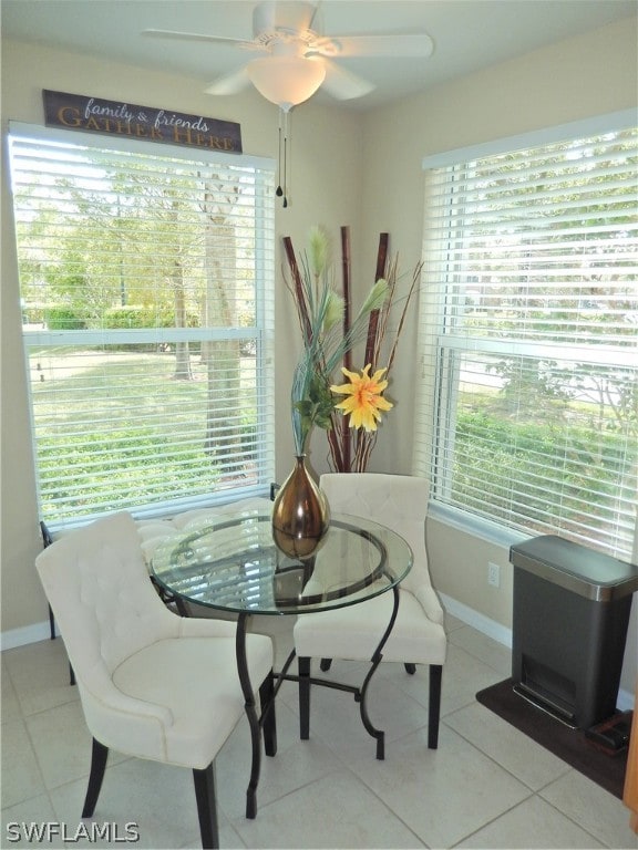 dining area with ceiling fan, light tile patterned floors, and a wealth of natural light