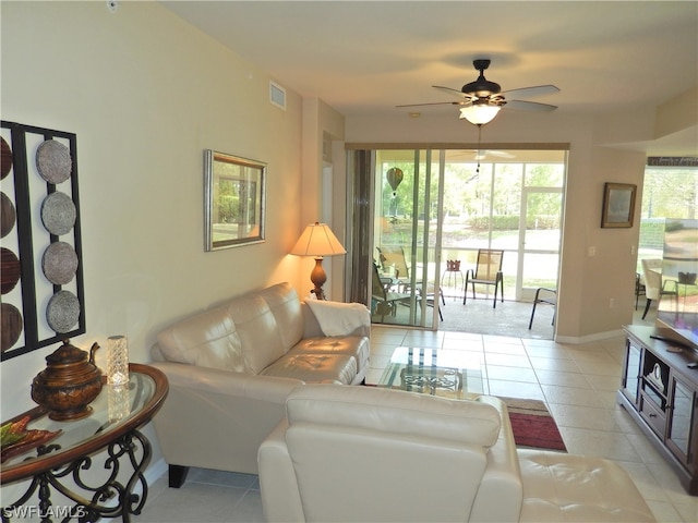 tiled living room featuring ceiling fan