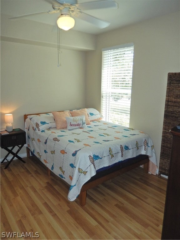 bedroom with ceiling fan and wood-type flooring