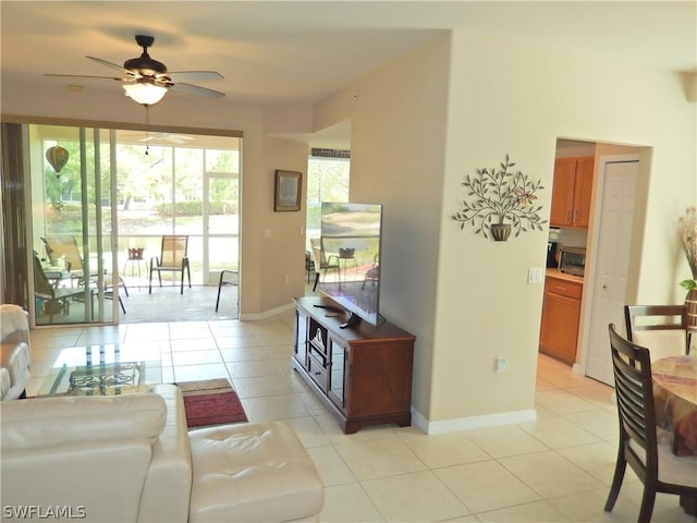 living room featuring ceiling fan and light tile patterned floors