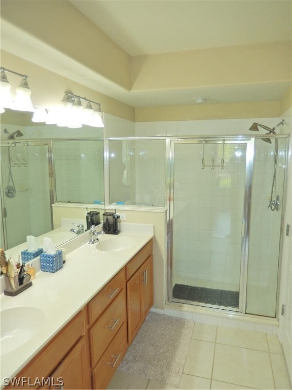 bathroom with tile patterned flooring, vanity, and a shower with shower door