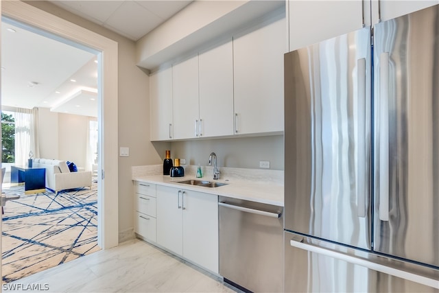 kitchen featuring sink, white cabinetry, and stainless steel appliances