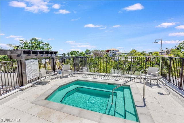 view of swimming pool with a pergola, a patio area, and a community hot tub