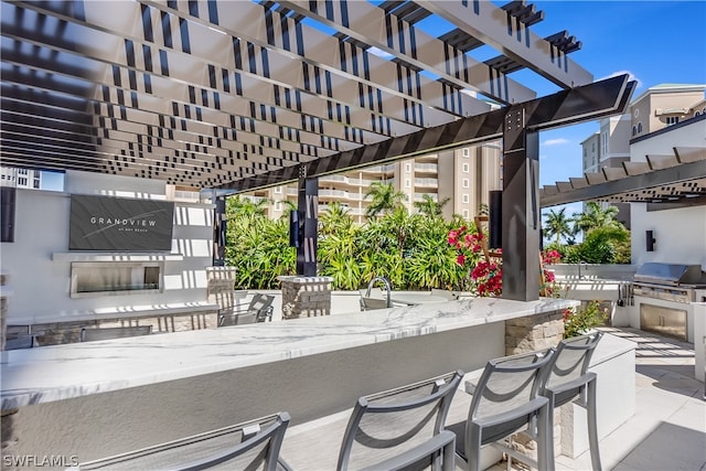 view of patio featuring a pergola, grilling area, and an outdoor bar