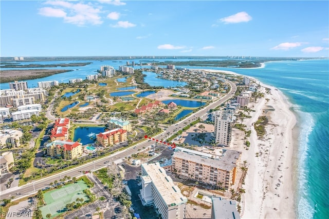 drone / aerial view featuring a water view and a view of the beach