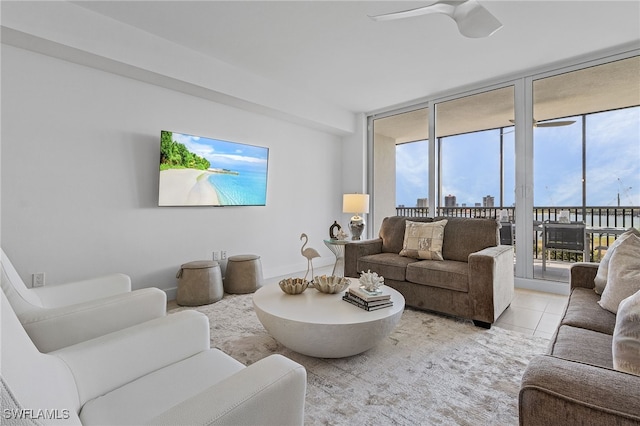 living room with ceiling fan and light tile patterned flooring