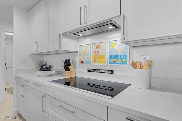 kitchen with white cabinets and black electric cooktop