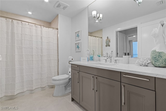 bathroom featuring tile patterned floors, vanity, toilet, and a chandelier