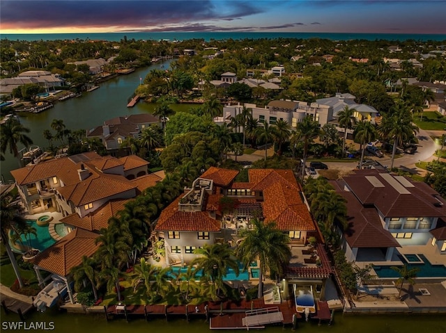 aerial view at dusk with a water view