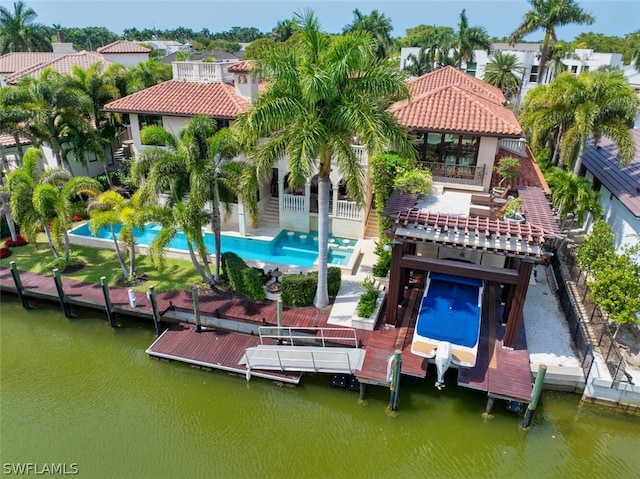 rear view of house with a water view and a patio