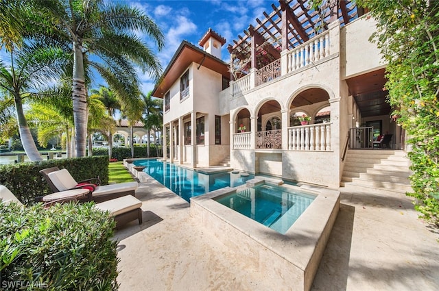 view of swimming pool with an in ground hot tub