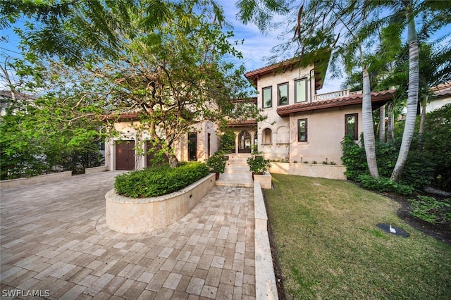 mediterranean / spanish home with a garage