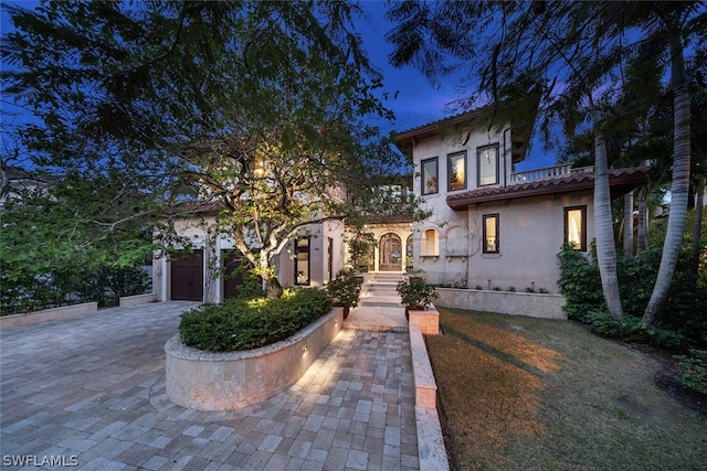 mediterranean / spanish home featuring a garage