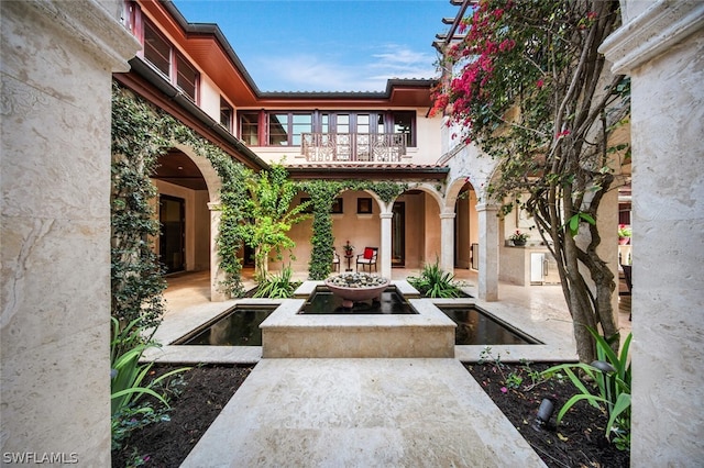 view of patio featuring a balcony