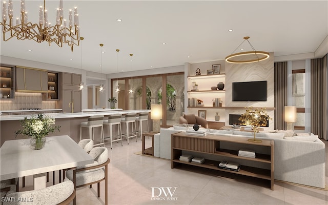 living room with plenty of natural light, light tile patterned floors, a chandelier, and sink