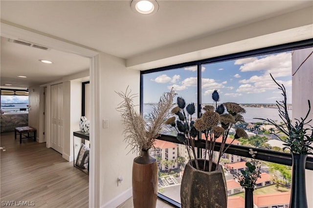 interior details featuring hardwood / wood-style floors and a water view