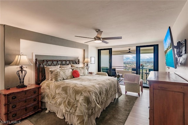 bedroom featuring floor to ceiling windows, access to exterior, ceiling fan, and wood-type flooring