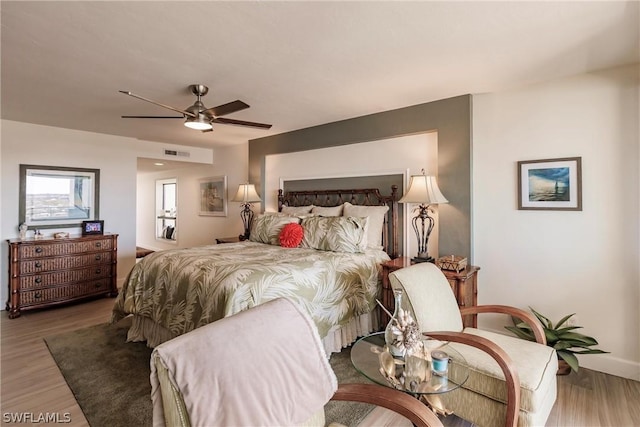 bedroom with hardwood / wood-style floors and ceiling fan