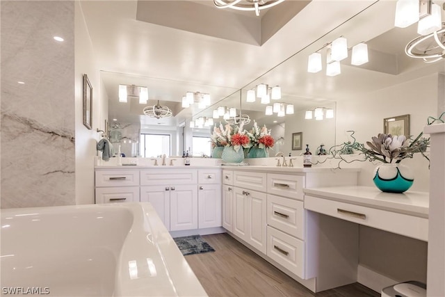 bathroom featuring a washtub, vanity, and wood-type flooring