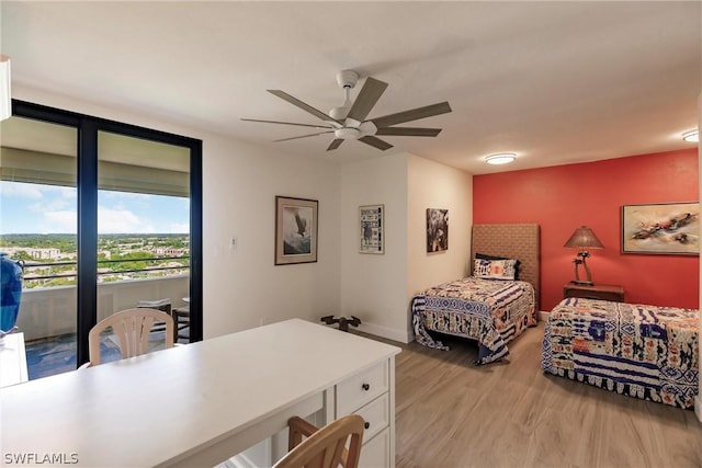 bedroom with access to exterior, light hardwood / wood-style floors, and ceiling fan