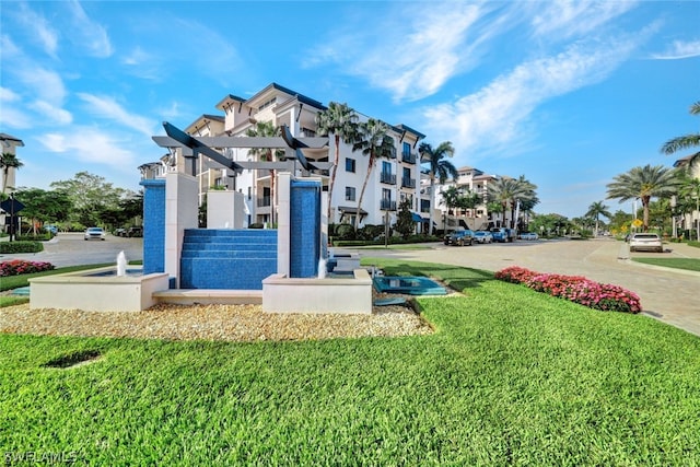 view of property's community with a playground and a lawn