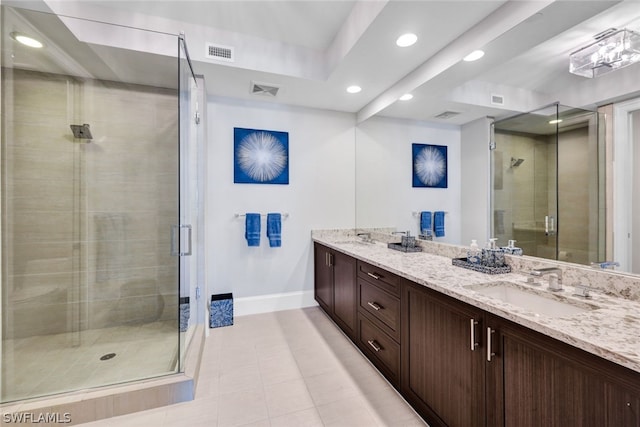 bathroom with vanity and a shower with shower door