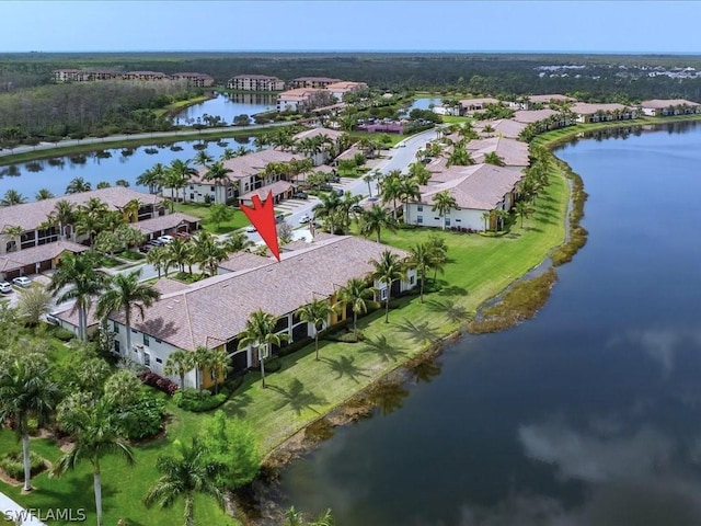 drone / aerial view featuring a residential view and a water view