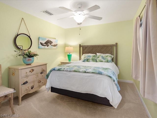 bedroom with light carpet, visible vents, baseboards, and ceiling fan