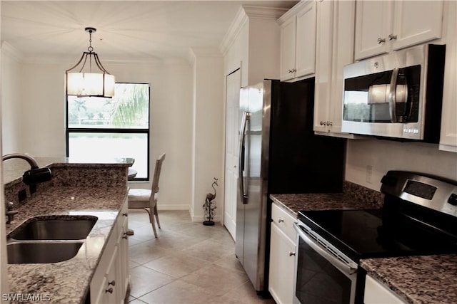 kitchen featuring a sink, stone countertops, white cabinetry, stainless steel appliances, and crown molding