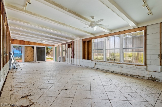 unfurnished sunroom with lofted ceiling with beams, ceiling fan, and rail lighting