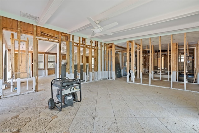 miscellaneous room featuring beam ceiling, ceiling fan, and a healthy amount of sunlight