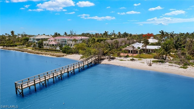 dock area with a water view and a view of the beach