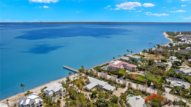 birds eye view of property featuring a water view and a beach view