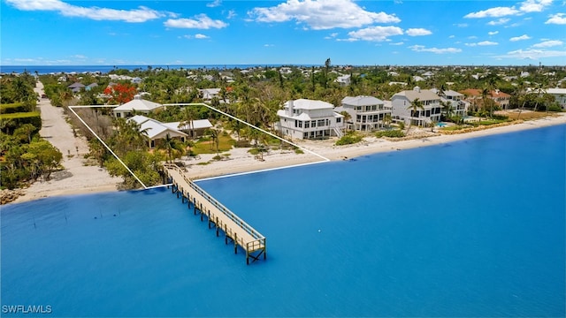 view of swimming pool featuring a water view and a beach view