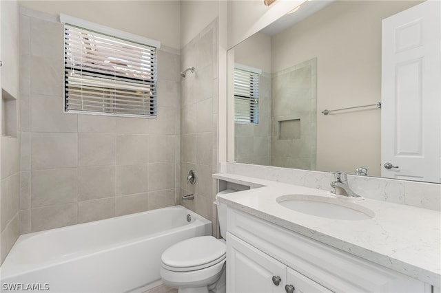 full bathroom with tiled shower / bath combo, oversized vanity, and toilet