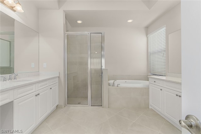 bathroom featuring plus walk in shower, tile floors, and vanity