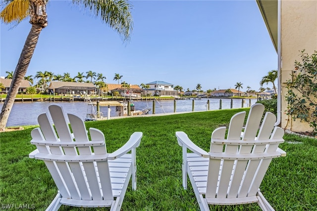 view of yard with a water view and a dock