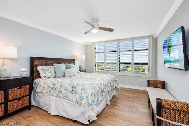 bedroom with ornamental molding, ceiling fan, and light hardwood / wood-style flooring