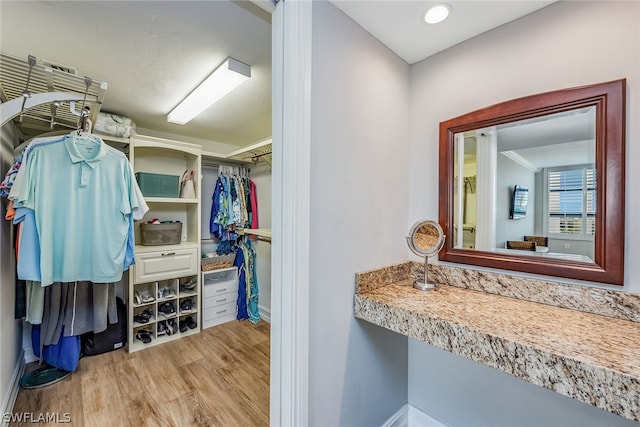 walk in closet with light wood-type flooring