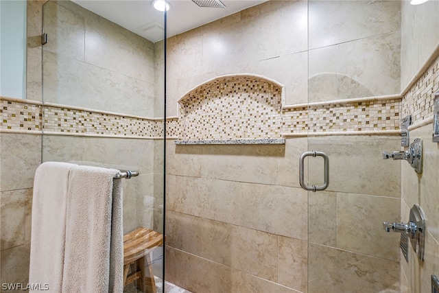 bathroom with tile walls and walk in shower