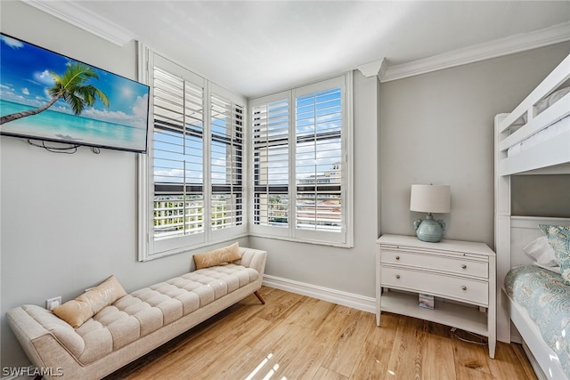 bedroom featuring crown molding and light wood-type flooring