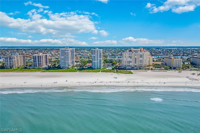 drone / aerial view featuring a beach view and a water view